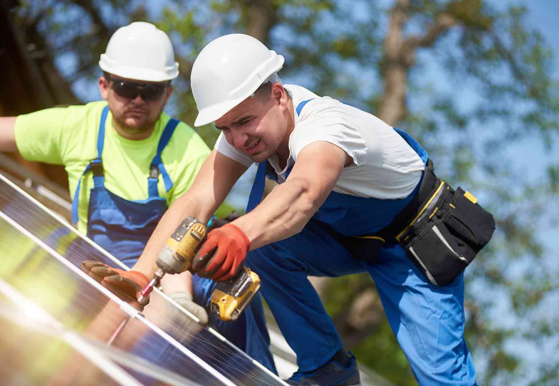 Two men installing a solar panel